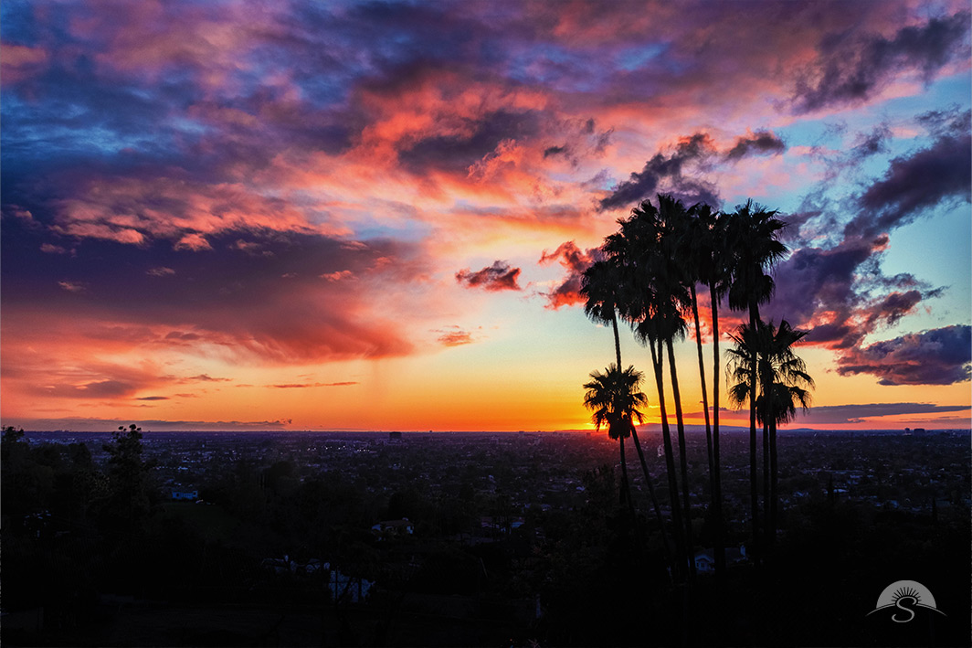 Experience the breathtaking beauty of Orange County, California, with this stunning landscape photo capturing a dramatic sunset just after a storm. The sky erupts in a vivid display of fiery oranges, deep purples, and soft pinks as the last remnants of the storm give way to nature’s brilliance. Silhouetted palm trees stand tall against the glowing horizon, adding a classic Southern California touch to this mesmerizing scene. The contrast between the storm’s lingering clouds and the sun’s golden light creates a one-of-a-kind composition that exudes both drama and serenity. Perfect for lovers of coastal sunsets and dynamic skies, this high-quality print will bring warmth and inspiration to any space. Order yours today and bring the magic of an Orange County sunset into your home!